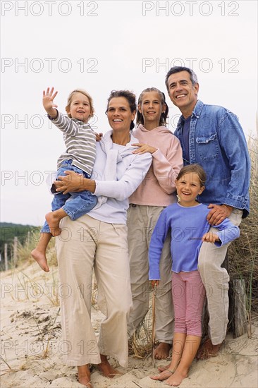 Caucasian family smiling on beach