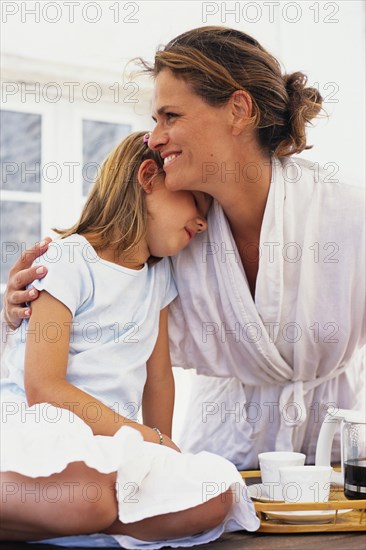 Caucasian mother and daughter hugging