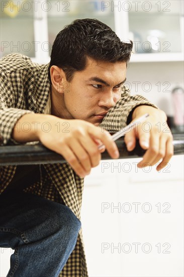 Bored man laying on counter top