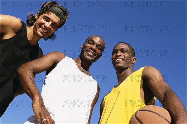 Men smiling on basketball court