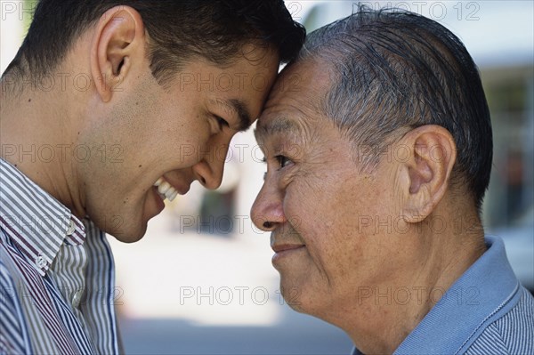 Senior man and son smiling outdoors