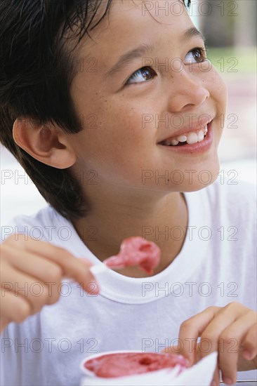 Boy eating ice cream outdoors