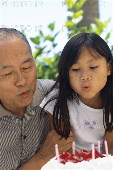 Senior man and granddaughter celebrating birthday