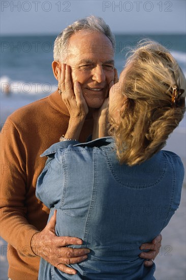 Senior couple hugging on beach