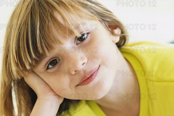 Girl resting head on hand