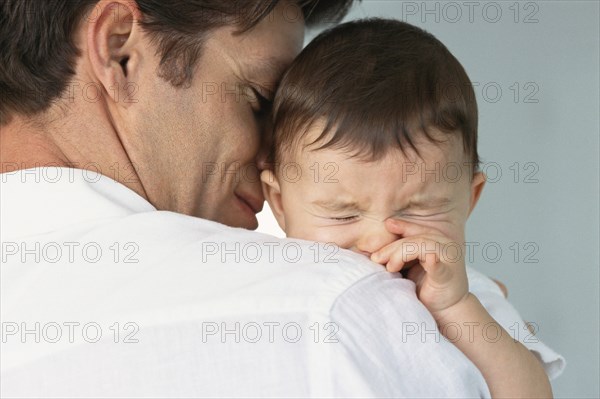 Father comforting crying baby