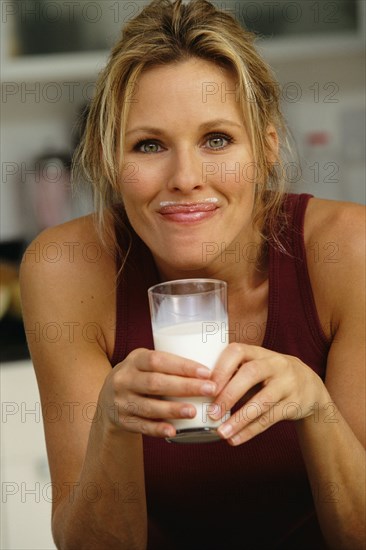 Woman smiling with milk mustache