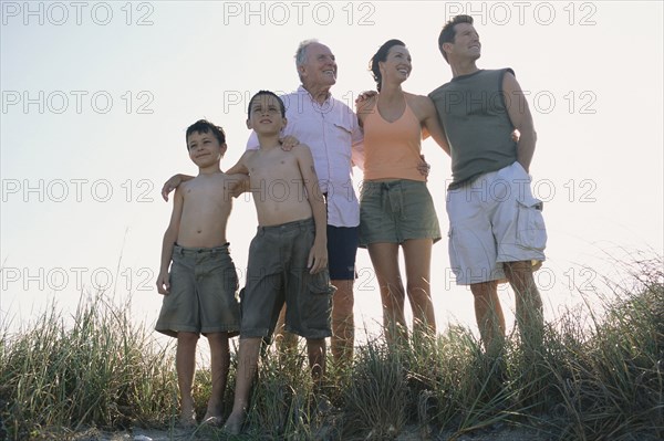 Family overlooking beach from hilltop