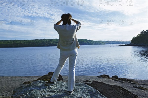 Senior woman overlooking rural lake