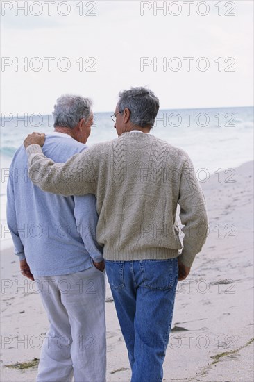 Caucasian father and son walking on beach