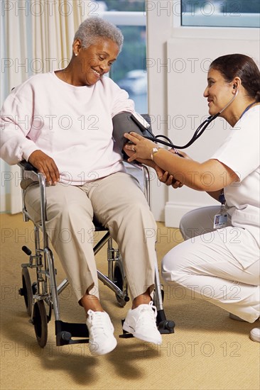 Nurse checking patient's blood pressure