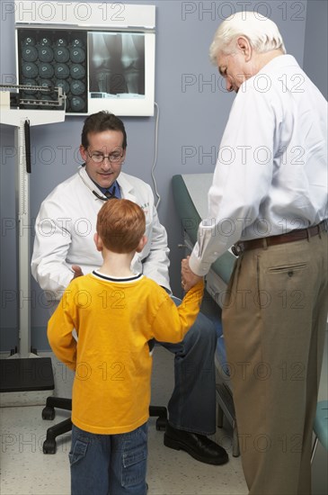 Senior man bringing grandson to doctor's visit