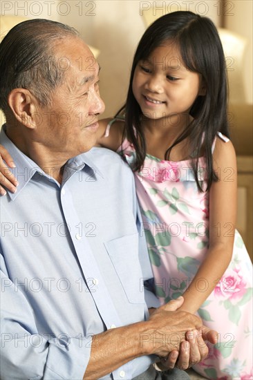 Senior man and granddaughter holding hands