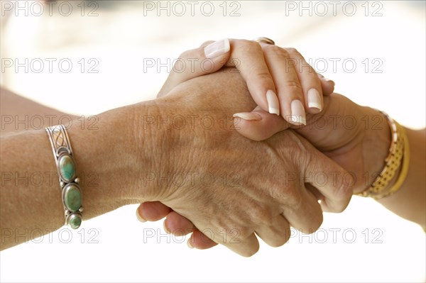 Senior women holding hands