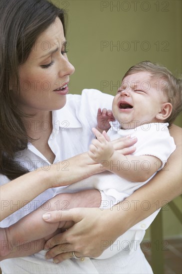 Mother comforting crying baby