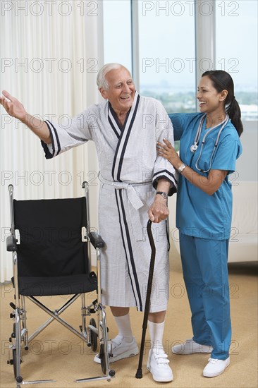 Nurse helping Senior patient use cane