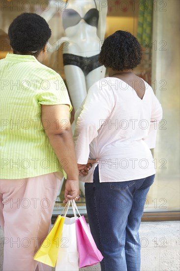 Women window shopping on city street