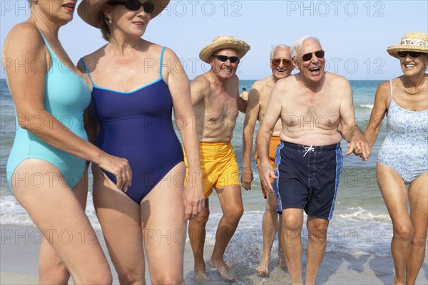Senior friends relaxing on beach