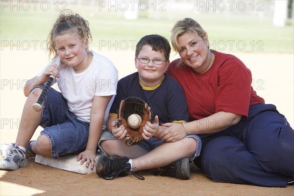 Mother and children smiling outdoors