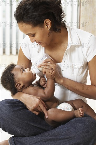 Mother bottle feeding baby