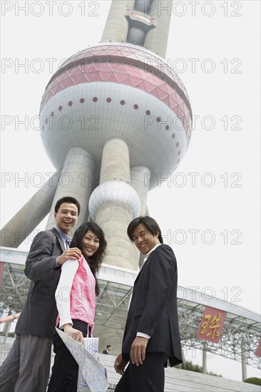 Chinese business people under Oriental Pearl Tower