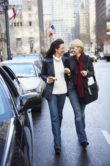 Women walking together on city street