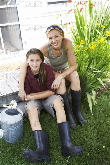 Mother and daughter smiling in backyard