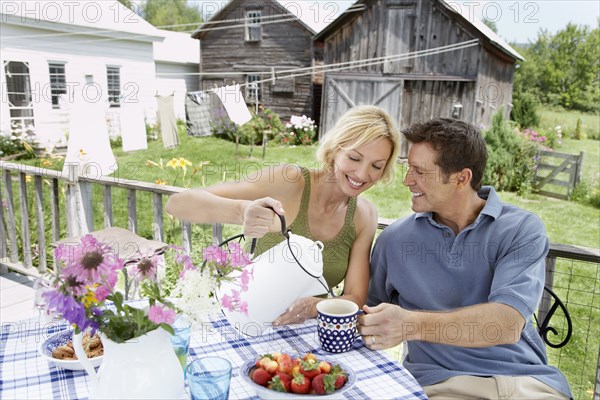 Couple having coffee on patio