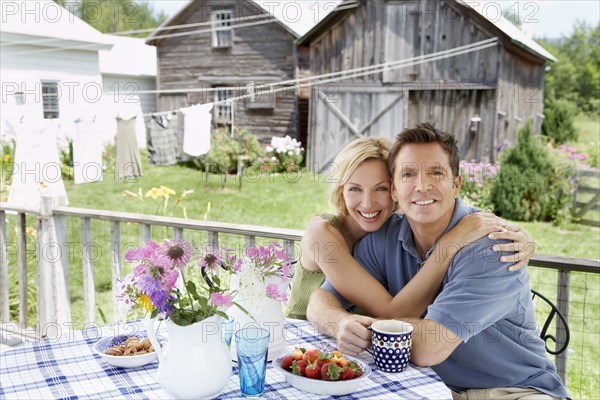 Couple having coffee on patio