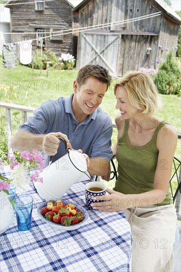 Couple having coffee on patio