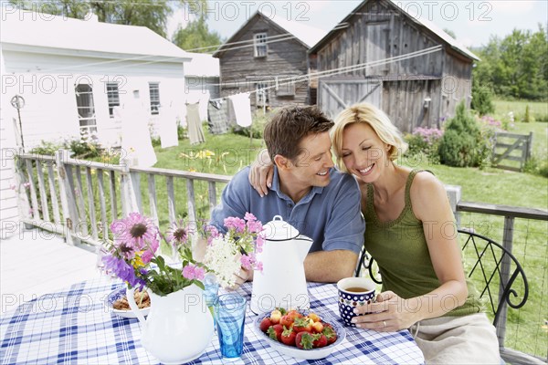 Couple having coffee on patio