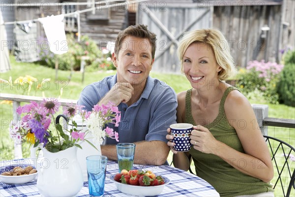 Couple having coffee on patio