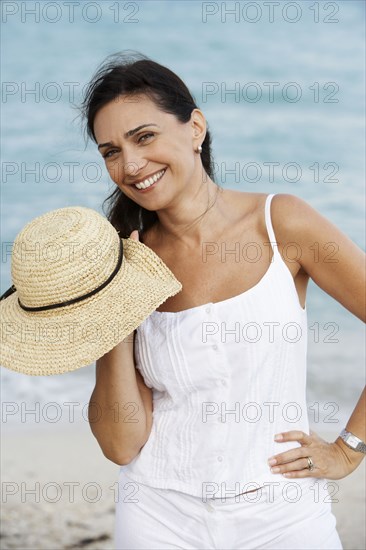 Hispanic woman smiling on beach