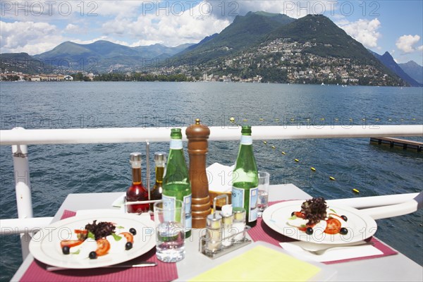 Plates of food at restaurant overlooking rural lake