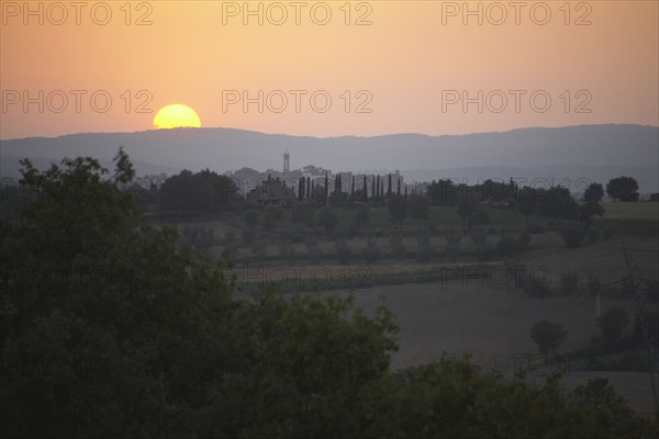 Sun setting over rural landscape