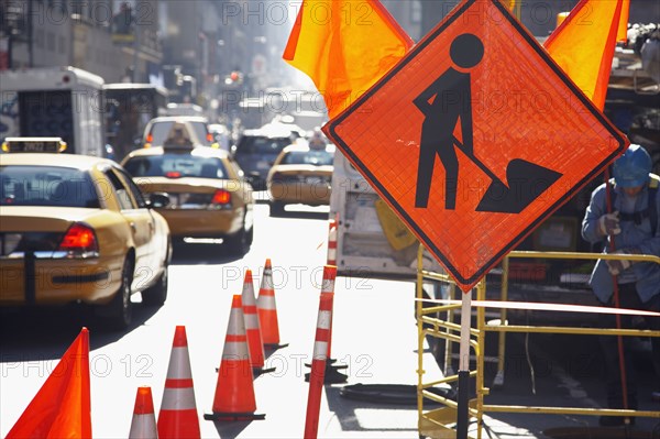 Traffic cones and sign on city street