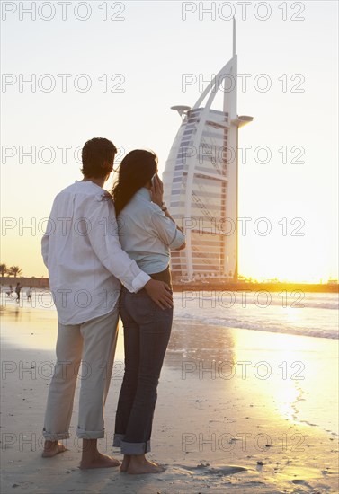 Couple admiring monument on beach