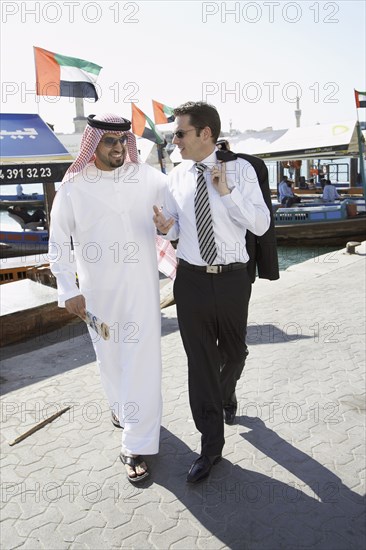 Businessmen talking on city street