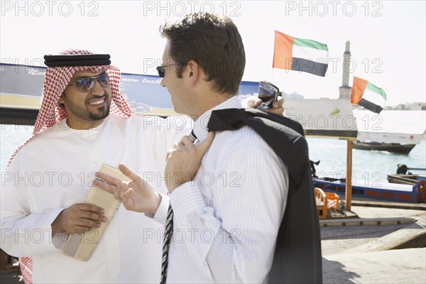 Businessmen talking on city street