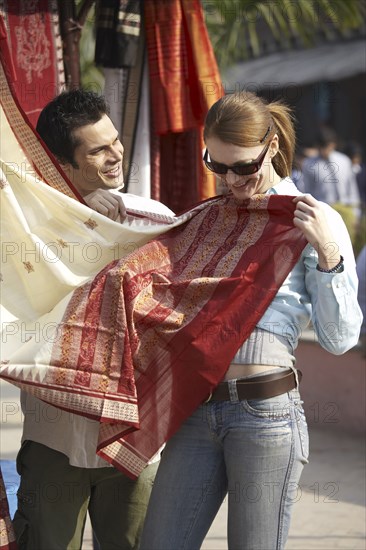 Couple admiring fabrics at outdoor market