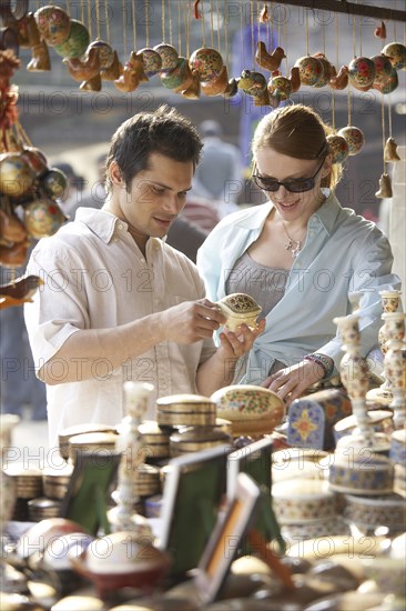 Couple buying food at outdoor market