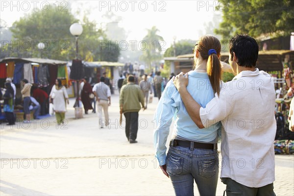 Couple walking in outdoor market