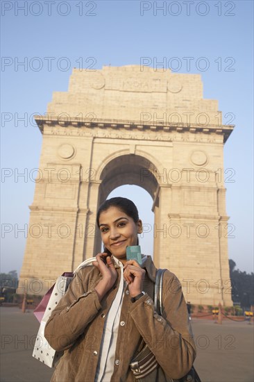 Indian woman smiling by India Gate