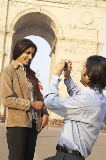 Indian couple taking pictures by monument