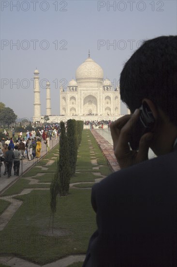 Indian businessman on cell phone by Taj Mahal