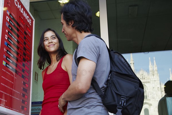 Couple checking currency exchange rates