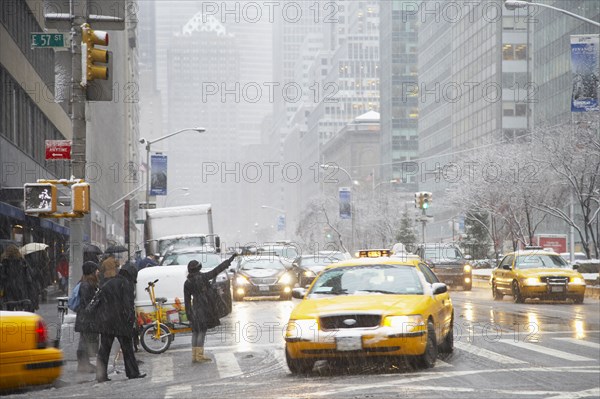 People hailing taxis on city street