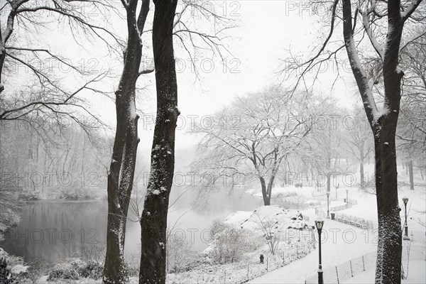 Lake in snowy urban park