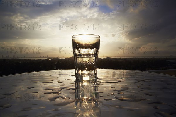 Empty glass on wet table outdoors