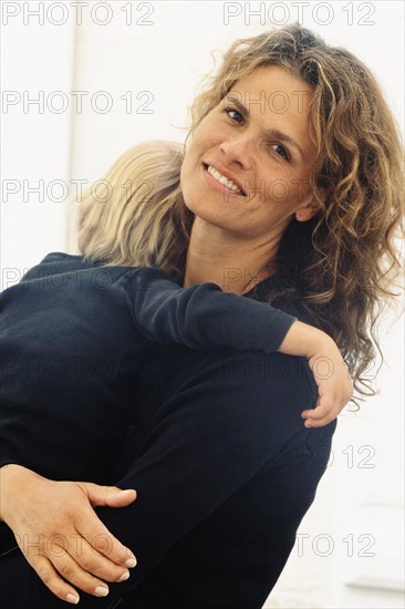 Caucasian mother holding son